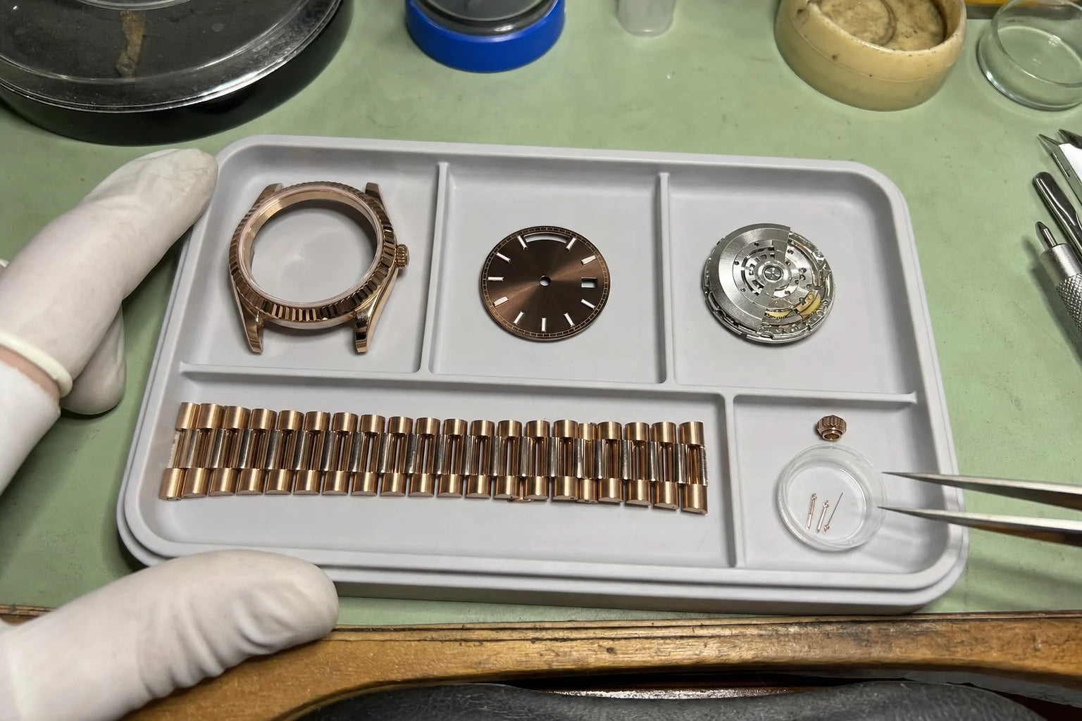 Watch components arranged for inspection at the workbench